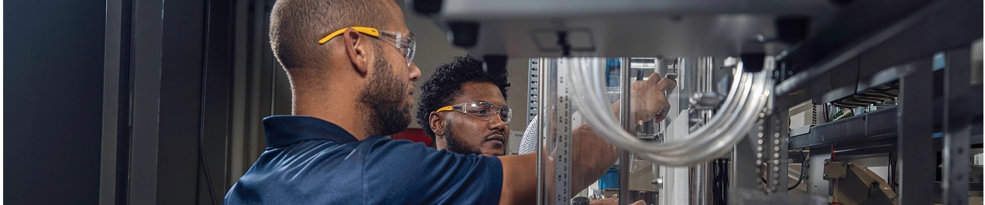 Two men examining industrial machinery