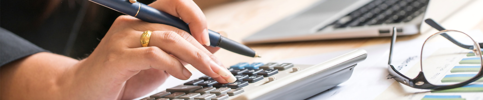 A woman looking at papers and using a calculator