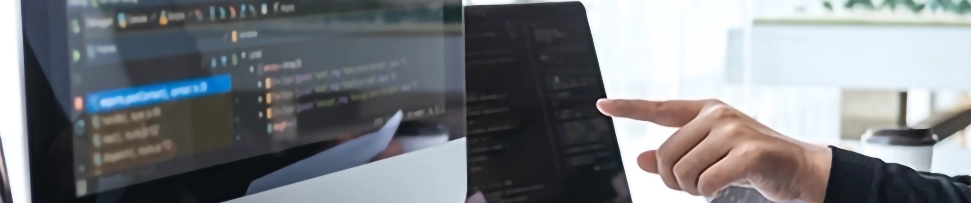 A person pointing at a computer screen