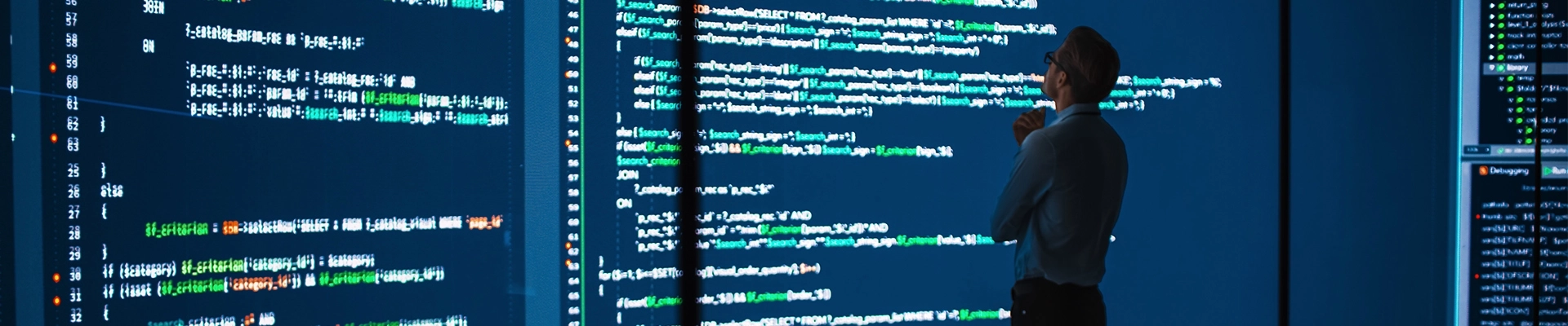 A person looking at a computer screen with a code editor on screen