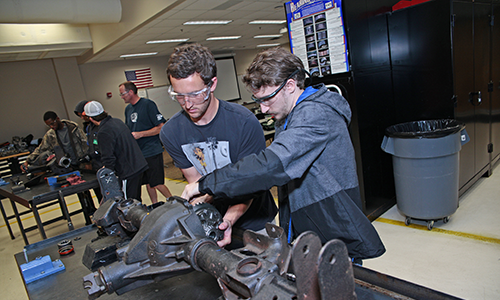 Image of person working on vehicle