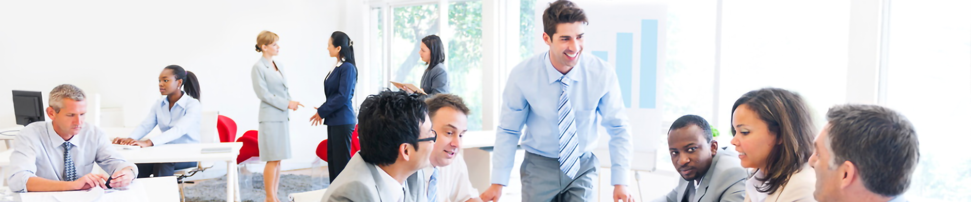 A man talking to several people in an office