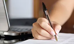 Person writing with pen