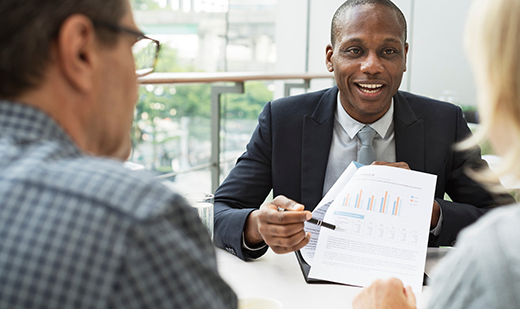 A man pointing to printed charts