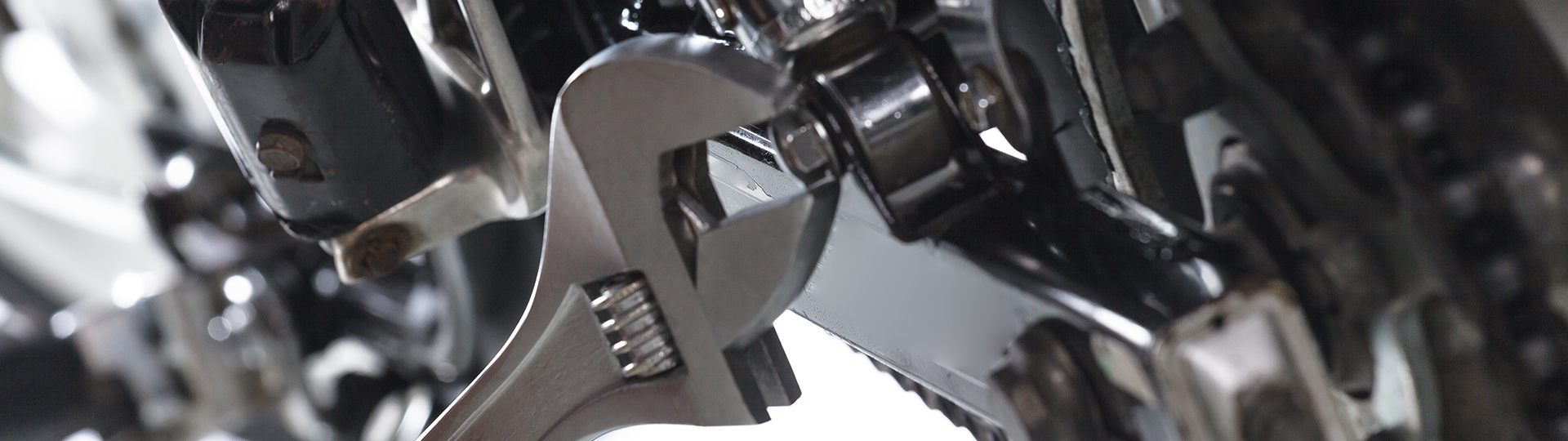 A wrench turning a bolt